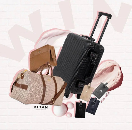AIDAN bags and suitcase featured in a giveaway with Alya Skin, stylish travel accessories on a pink background.