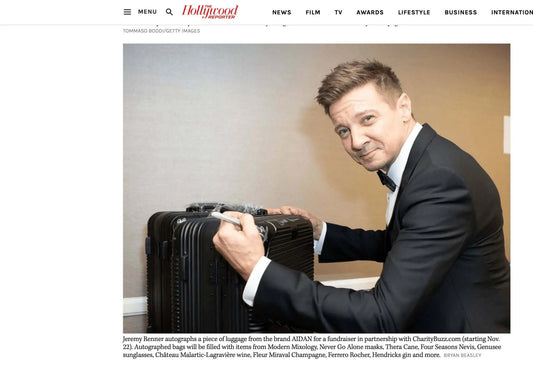 Jeremy Renner autographs a suitcase at The American Cinematheque Gala fundraiser for CharityBuzz.com.